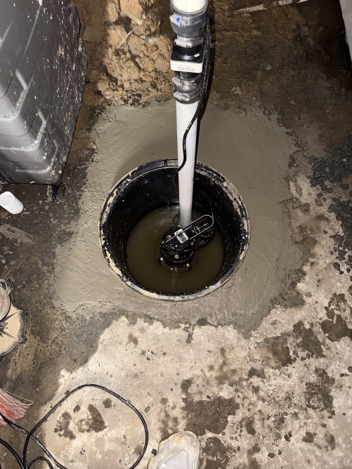 Sump pump installed inside an open basement sump basin