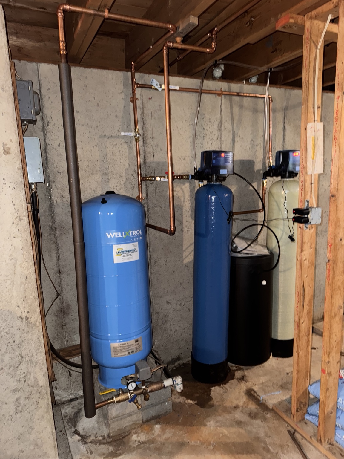 Interior pressure tank, gauge and switch assembly, water-treatment vessels, and connected copper piping